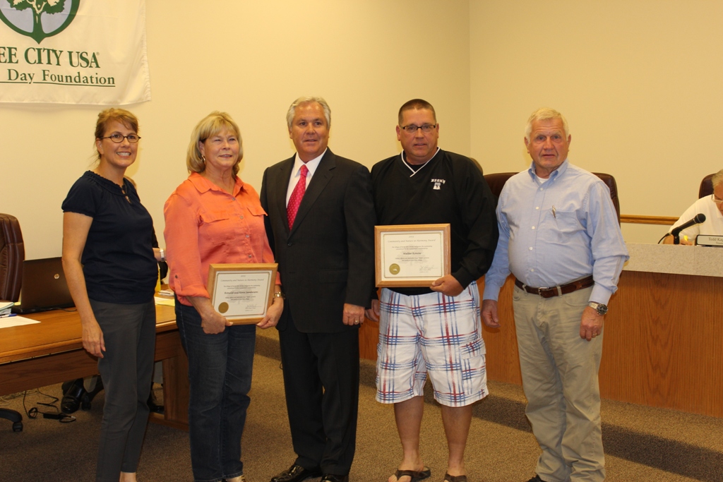 Group Photo With Two People Holding Awards
